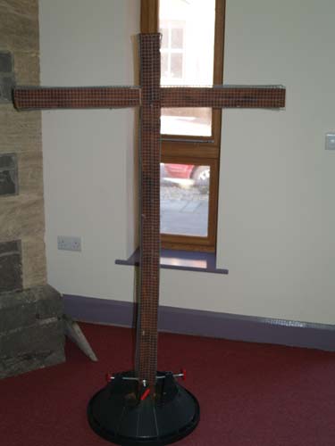 The bare wooden cross.