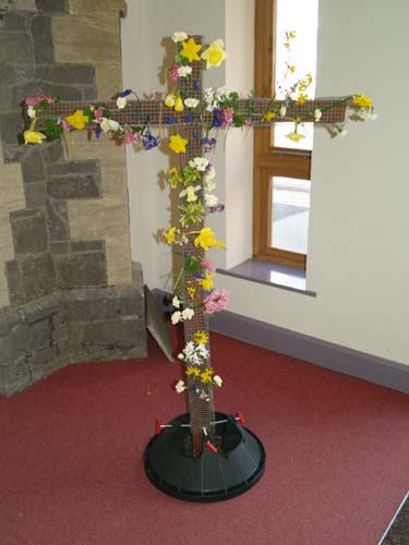 The cross decorated with flowers.