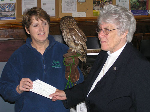 Reverend Joyce Plumb presenting a cheque to Pauline Kidner, from Secret World.